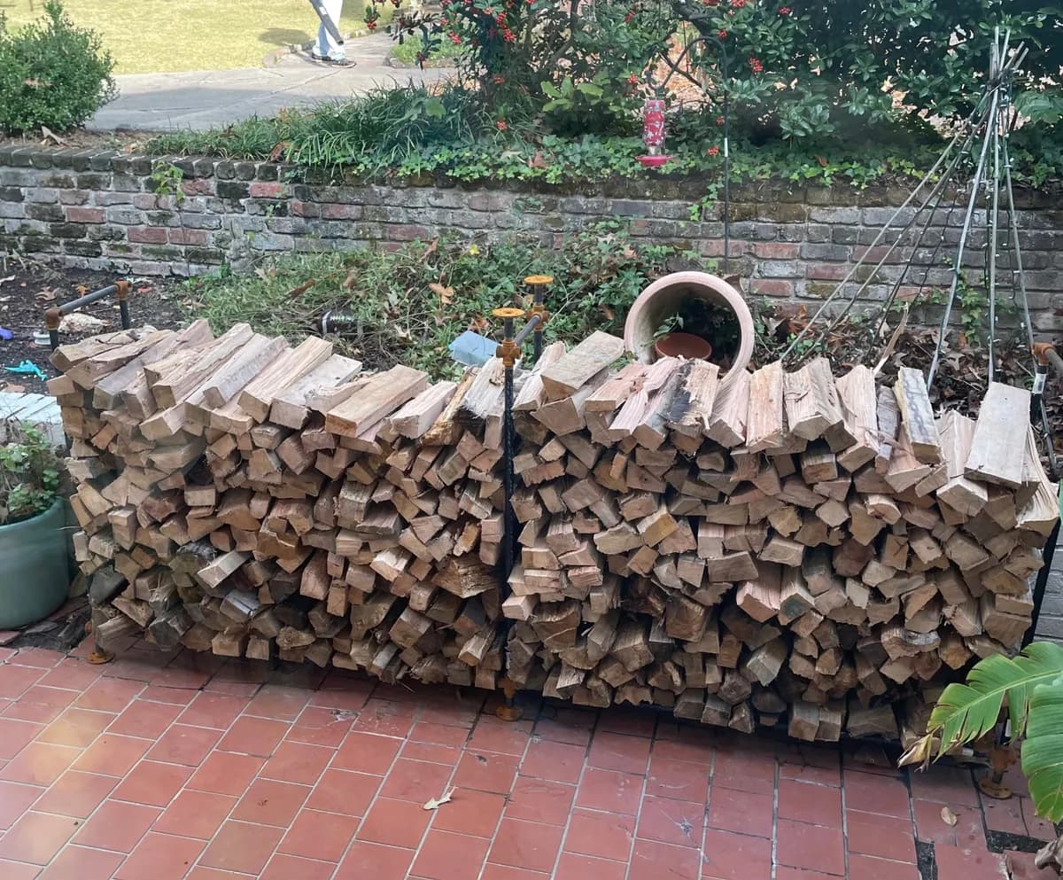 Full truckload of firewood stacked 4 feet high by 8 feet wide